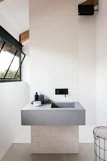 A look at the simple, modern bathroom with a monolithic sink.