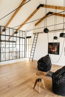 A versatile leisure room connects to a fully-glazed study and work room.