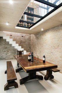 Standing within the conservatory, a glass floor allows one to see through to the wine cellar below, which is accessible via a seamlessly integrated trap door. 