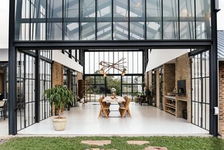 When the glass partitions are open, the passive heat from the conservatory is then released into the adjoining living spaces. 