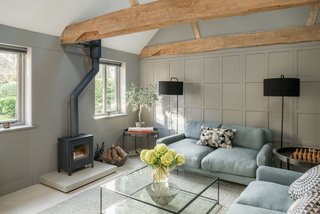 A living lounge with a wood-burning fireplace.