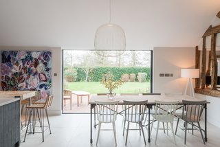 A crisp palette of light neutral colors conveys a clean, contemporary, and serene vibe within the open-plan common areas. 