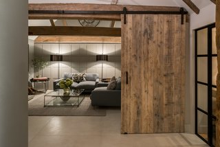 Wooden sliding doors recall barn and farmhouse aesthetics.