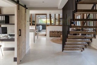  The steel balustrade of the staircase complements the industrial-style Crittall windows used throughout the house. 