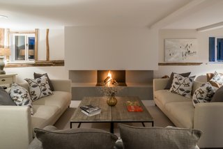 This exposed log-burning fireplace appears as if it has been carved out of the chimney breast.