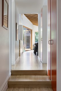 American Oak timber flooring and a built-in sofa add continuity throughout the home.