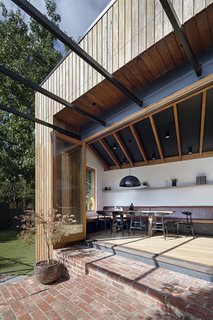 Restaurant-style banquette seating extends from the kitchen bench, wrapping around the end of the addition and above. 