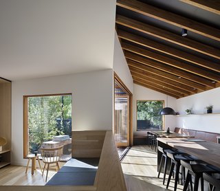 A large built-in sofa, inspired by the work of Donald Judd, divides the kitchen from the living room while still allowing a visual connection.
