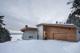 The wood siding gives the house a cabin-like aesthetic.