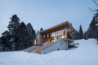 "The project is designed as a delicately carved volume, which nestled into the site following its topography. The formal gestures are strong and powerful, while the material—sandy beige wood and red cedar slats—are more delicate and warm," says Bourgeois.