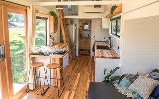 The sleeping area is contained within a cozy loft that’s accessible via a carpeted, handmade cypress pine ladder.