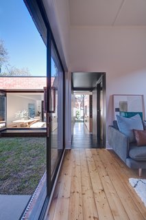 Existing timber floorboards in the old house were sanded and re-polished.