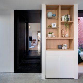 Oak timber recessed ‘boxes’ are used as bookshelves, wine storage, and display cabinets.
