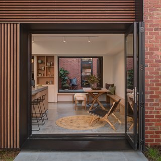 One side of the exterior is clad in spotted gum timber battens.