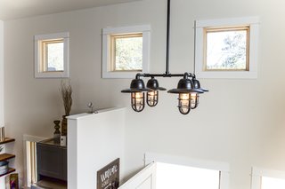 An Edison bulb chandelier made from steel pipe.