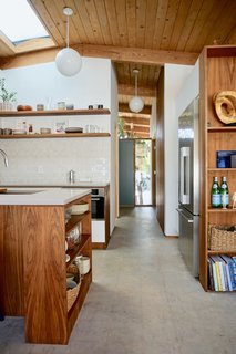 The contractor installed the walnut trim, shelving, and cabinets sides and backing on site.