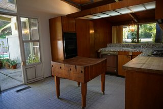 The original L-shaped kitchen was closed off and lacked storage, so Martin opened it up by taking out the doorway to the hall and extending the space to the ceiling.