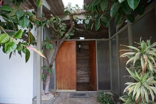 The couple sanded, repaired, and sealed the wood ceilings, exterior overhangs, wood beams, posts, and window trim inside and out. 
