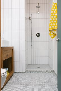 SomerTile silk penny round mosaic floor tiles of the guest bathroom. 