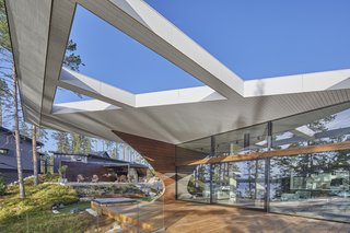 A cantilevered section of the roof with geometric cutouts.