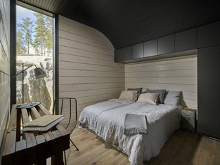 Additional bedrooms located on the opposite site of the home look out toward a forest. 
