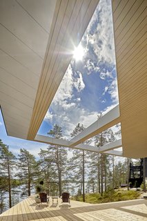 A terrace looks out to tree and lake views.