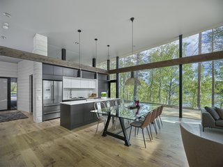 The living area has glass walls that bring in an abundance of sunlight. Most of the floors are wood and parquet.