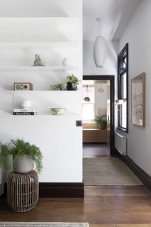 A hallway in the original house connects the living room to a bathroom.