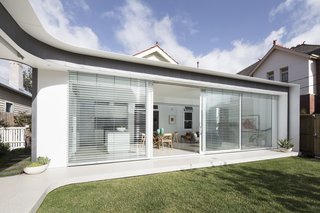 Fully glazed sliding doors open to connect with the garden.