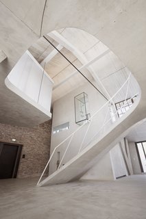 A glass-encased shower block cantilevers 16 feet above the main level. 