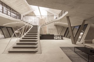 A sweeping concrete staircase leads the the upper levels of Loft Panzerhalle.
