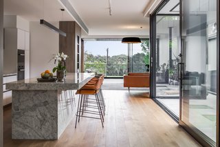 As with the external materials, the internal finishes are robust and earthy with the stone for the kitchen countertops chosen for its ability to handle the brightly colored spices and powders of Indian cuisine.