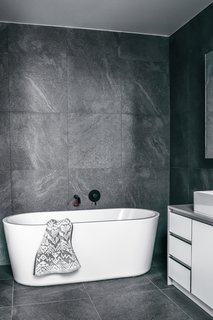 A Posh Solus freestanding bath anchors the bathroom.
