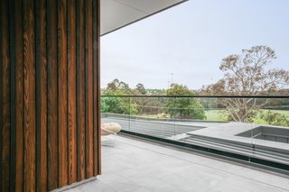 The burnt ash exterior timber cladding by Woodform Architectural features alternating thicknesses.