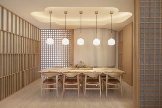 Pendant lights from Rubn hang over a private dining space, and textured plaster walls from Armourcoat echo the wooden screens.