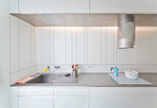 Stainless steel counters stretch across the length of the kitchen.