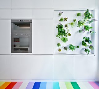 The multi-hued rubber floor echoes the color swatches that the owner, a fashion designer, interacts with.