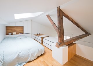 The natural light coming down from the second skylight bypasses the mezzanine to reach the bathroom at the lower level.