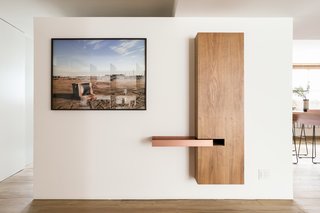 Pascali Semerdjian designed this copper tray that extends from a wooden wall feature.