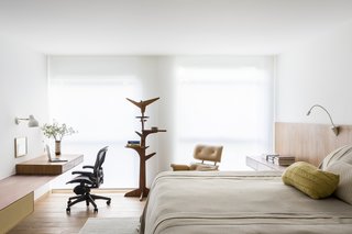 The master bedroom features a Pedro Useche coat rack and an Eames chair.