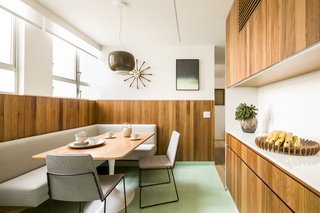 This dining nook features an Oscar Tusquets table and Peroba do Camp flooring by Oscar Ono.