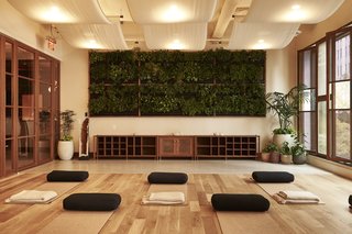 The yoga room features Terramai wood flooring and ceiling fabric from Holland & Sherry.