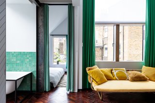 A sitting area and bathroom are located outside one of the bedrooms.