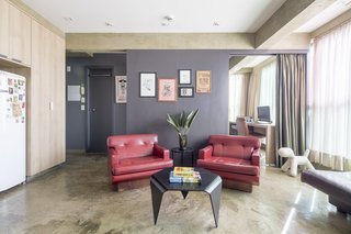 The owner's vintage armchairs have a bold presence in the living room.
