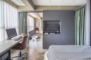 One of the curtains opens to connect the bedroom with the living space.
