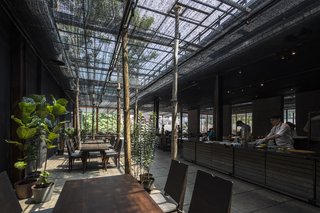 To shield the interiors from strong sunlight, this restaurant in central Ho Chi Minh City is clad in an agricultural net made from polyethylene that was initially developed for agricultural purposes, but quickly found its way into vernacular buildings because of its cost-effectiveness. NISHIZAWAARCHITECTS experimented with the netting, using shadow and light to help compose space.