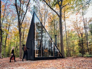 Measuring only 180 square feet, this sleek, prefabricated, off-grid tiny home rotates the classic A-frame cabin structure by 45 degrees to create more usable floor space. Sited in Hudson Valley, the sleek, black cabin by BIG and prefab housing startup Klein is the first model in a series of tiny homes that Klein plans to sell directly to consumers.