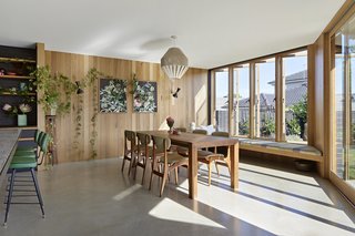The dining area looks out to the green backyard.