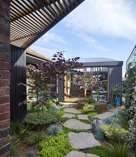 A courtyard creates visual separation between the main house and the addition.