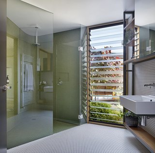 A bathroom with a corner shower.
